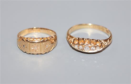 Two early 20th century 18ct gold and diamond set dress rings.